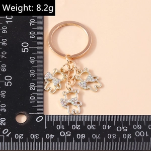 Detailed view of lightweight golden bear keychains featuring sparkling rhinestone bow ties
