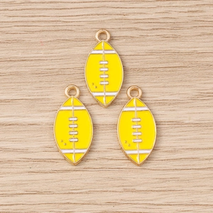 Detailed close-up of yellow enamel American football pendants with golden metal outlines