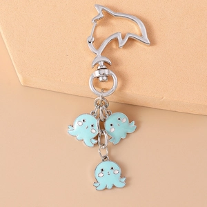 Detail of octopus keychain with dolphin-shaped carabiner and light blue charms