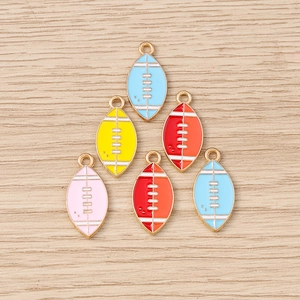 Set of 6 colorful enamel rugby charms with gold alloy bases on a wood background
