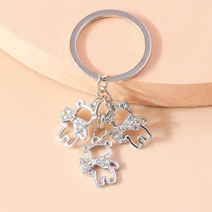 Luxury silver bear keychain with sparkling rhinestone bows and shiny metallic finish