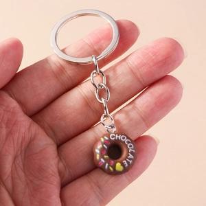 Detailed close-up of chocolate donut keychain with colorful sprinkles and heart ornament