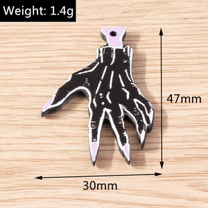 Detail view of Halloween bone hand charm with 47mm height and 1.4g weight measurements