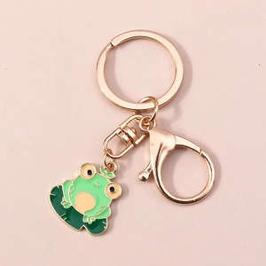 Vue détaillée du porte-clés grenouille dorée avec émail vert assis sur un nénuphar