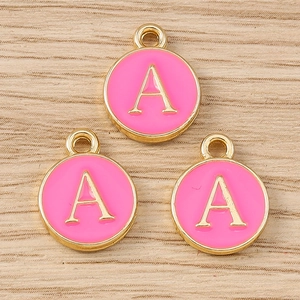 Detailed view of pink enamel alphabet A round charms with gold metal finish for DIY jewelry making
