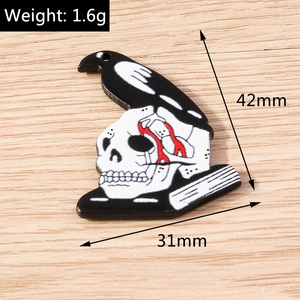 Macro detail of Halloween skull and raven pendant with 42mm by 31mm size markings