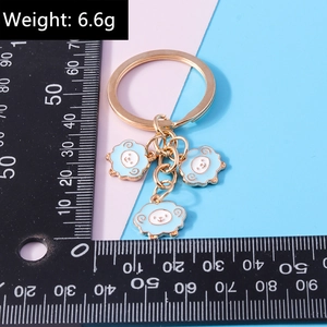 Detailed view of light blue sheep charms on golden keychain with 6.6g weight data