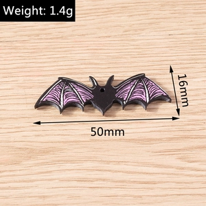 Detailed view of a black and purple resin bat pendant with dimensions 50mm x 16mm