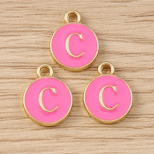 Detailed view of three pink enamel letter C pendants with gold trim for DIY jewelry