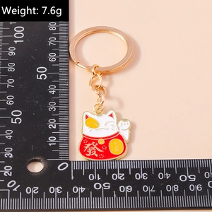 Detailed view of Maneki Neko keychain featuring gold Fa character and weight of 7.6g