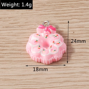 Detailed macro view of a pink resin donut pendant with bow and metal ring for DIY jewelry