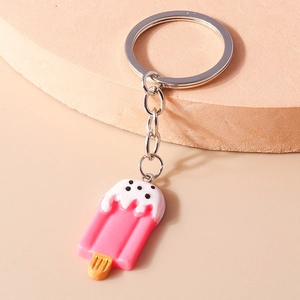 Close-up of creative pink popsicle keychain with white cream and silver metal ring