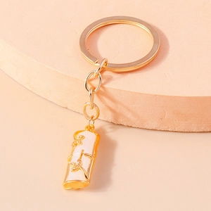Detail of bamboo joint pendant in faux white jade with gold floral relief and metal ring