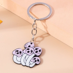Detailed macro view of purple mushroom skull keychain with silver metal ring and chain