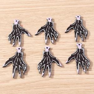 Macro detail of 6-piece black Halloween skeleton hand charms for DIY jewelry making