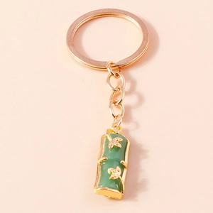 Detailed view of bamboo joint keychain with green faux jade and golden leaves