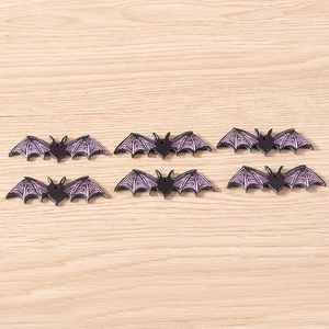 Detailed view of six black and purple resin bat charms for Halloween DIY jewelry making