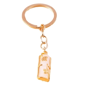 Elegant gold metal keychain with pink imitation jade bamboo pendant and floral relief