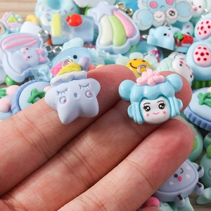 Detail shot of cute pastel resin charms for DIY jewelry making with cartoon flower and stars