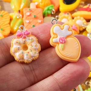 Detail showing various resin cartoon charms with silver loops for DIY jewelry making