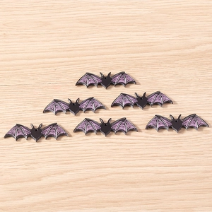 Detailed view of six resin Halloween bat charms with purple wing textures for DIY jewelry