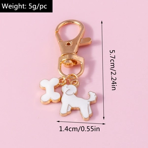 Detailed view of bone and dog charms with measurements on a pink background