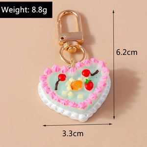 Close-up of heart cake keychain with realistic fruit and dimensions 6.2cm by 3.3cm