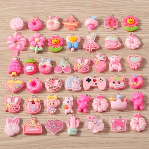 Detailed view of assorted pink resin DIY pendants with cute cartoon and floral shapes