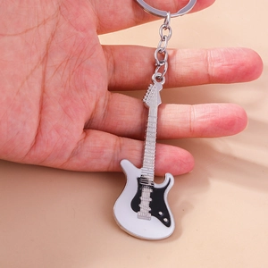 Fashionable electric guitar metal keychain with classic black and white finish in hand