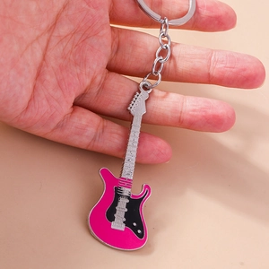 Close-up of a creative rose red and black enamel guitar keychain with silver metal ring