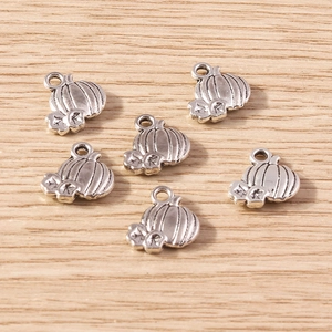 Detailed view of six vintage silver pumpkin pendants with rustic antique finish for DIY crafts