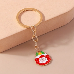 Dettaglio portachiavi Babbo Natale dorato con smalto colorato e campanellino decorativo