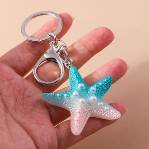 Cute cartoon resin starfish keychain with blue-pink gradient and white pearls