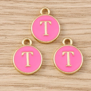 Detailed close-up of three pink enamel gold letter T charms for DIY jewelry making