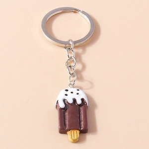 Detail view of a chocolate popsicle keychain featuring a white cream top and silver metal ring