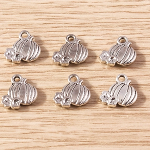 Detailed view of six vintage silver pumpkin charms for Halloween jewelry making and DIY crafts