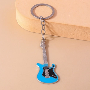 Close-up of a blue mini guitar keychain with intricate metal details and smooth enamel finish
