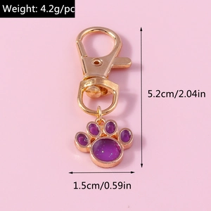Detail view of purple glitter paw pendant with dimensions 5.2cm length and lobster clasp