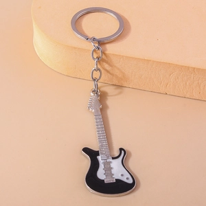 Detailed view of creative electric guitar keychain with black and white enamel finish