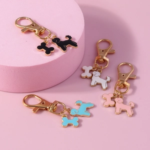 Set of 4 cute cartoon dog and bone enamel keychains in black, white, blue and pink colors