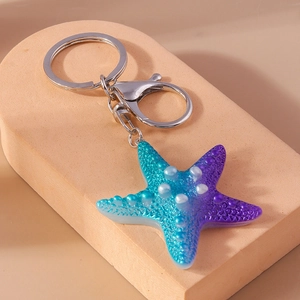 Detail of blue-purple gradient resin starfish keychain with silver metal lobster clasp