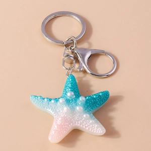 Close-up of resin starfish keychain with gradient colors and pearl accents detail