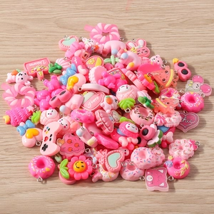 Macro shot of assorted pink resin charms including donuts and bears for DIY jewelry