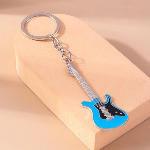 Macro detail of sky blue guitar keychain with zinc alloy base and smooth enamel finish