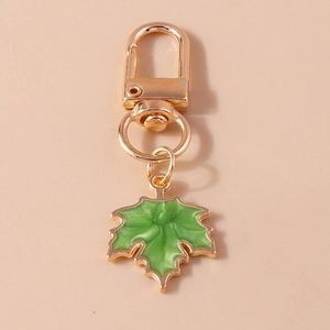Close-up of green enamel maple leaf keychain with gold-plated lobster clasp and ring