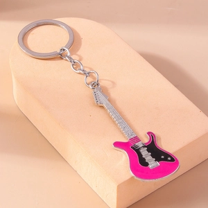 Detailed close-up of a pink and black electric guitar keychain on a display stand