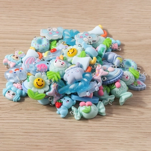 Close-up of colorful resin flower and heart charms for DIY jewelry making accessories