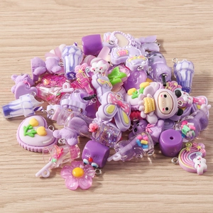 Detailed macro view of assorted purple resin cartoon charms for DIY jewelry making