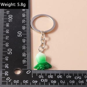 Detailed view of cabbage pendant keychain with realistic green texture on pink background