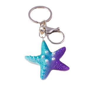 Cute resin starfish keychain with blue-purple gradient and white dots on white background